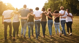 Group of people with arms around their shoulders